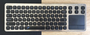 Silver keyboard with black keys and touchpad